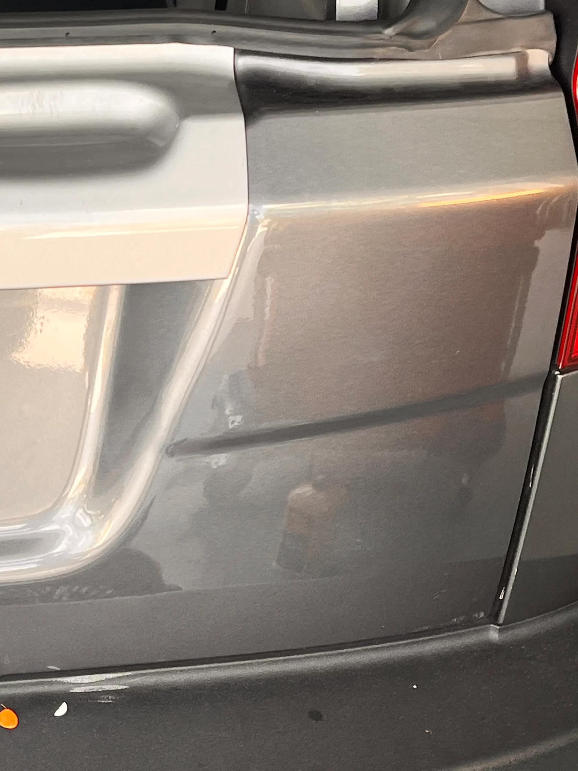 The opened-up back of a grey SUV with its interior shown after repairs were made.